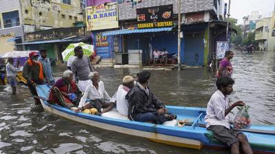 People travel on a boat in floodwaters on the outskirts of Chennai on Wednesday. Heavy rainfall will continue across Tamil Nadu state through November 11, according to IMD. (AP) People travel on a boat in floodwaters on the outskirts of Chennai on Wednesday. Heavy rainfall will continue across Tamil Nadu state through November 11, according to IMD. (AP)