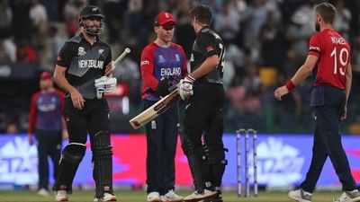 Abu Dhabi : England's captain Eoin Morgan centre, greets New Zealand's Mitchell Santner at the end of the Cricket Twenty20 World Cup semi-final match between England and New Zealand in Abu Dhabi, UAE, Wednesday, Nov. 10, 2021. AP/PTI(AP11_10_2021_000320A) (AP) Abu Dhabi : England's captain Eoin Morgan centre, greets New Zealand's Mitchell Santner at the end of the Cricket Twenty20 World Cup semi-final match between England and New Zealand in Abu Dhabi, UAE, Wednesday, Nov. 10, 2021. AP/PTI(AP11_10_2021_000320A) (AP)