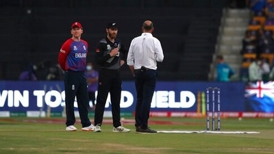 New Zealand's captain Kane Williamson, center, speaks to the commentator after winning the toss as England's captain Eoin Morgan, left, looks on ahead of the Cricket Twenty20 World Cup semi-final match between England and New Zealand in Abu Dhabi, UAE, Wednesday, Nov. 10, 2021. (AP Photo/Aijaz Rahi) (AP) New Zealand's captain Kane Williamson, center, speaks to the commentator after winning the toss as England's captain Eoin Morgan, left, looks on ahead of the Cricket Twenty20 World Cup semi-final match between England and New Zealand in Abu Dhabi, UAE, Wednesday, Nov. 10, 2021. (AP Photo/Aijaz Rahi) (AP)