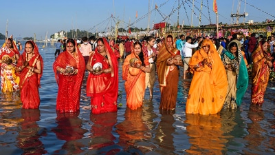 Devotees perform rituals during Chhath Puja at the bank of the Brahmaputra river in Guwahati on Wednesday. (PTI)