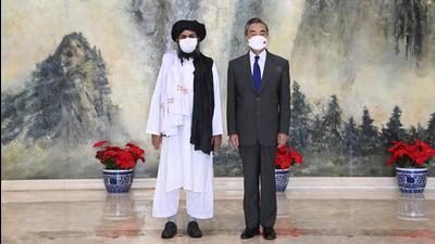 In this July 28 photo, Taliban co-founder Mullah Abdul Ghani Baradar (left) and Chinese Foreign Minister Wang Yi pose for a photo during their meeting in Tianjin, China. (AP) In this July 28 photo, Taliban co-founder Mullah Abdul Ghani Baradar (left) and Chinese Foreign Minister Wang Yi pose for a photo during their meeting in Tianjin, China. (AP)