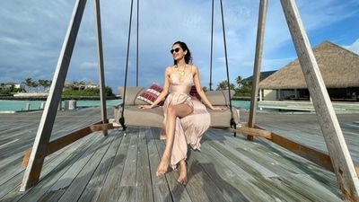 Manushi shared another picture of herself posing on a wooden swing by the sea. For this photo, the Prithviraj actor wore a blush pink strappy gown. It featured a plunging neckline, fit-and-flare silhouette, and a thigh-high slit. (Instagram/@manushi_chhillar) Manushi shared another picture of herself posing on a wooden swing by the sea. For this photo, the Prithviraj actor wore a blush pink strappy gown. It featured a plunging neckline, fit-and-flare silhouette, and a thigh-high slit. (Instagram/@manushi_chhillar)