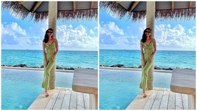 One of the last looks of Manushi shows her wearing a strappy cowl neck crop top with high-waist flared pants in an olive green shade. She posed on a dock by the infinity pool for the stunning click. Gold accessories and floral sandals completed Manushi's attire. (Instagram/@manushi_chhillar) One of the last looks of Manushi shows her wearing a strappy cowl neck crop top with high-waist flared pants in an olive green shade. She posed on a dock by the infinity pool for the stunning click. Gold accessories and floral sandals completed Manushi's attire. (Instagram/@manushi_chhillar)