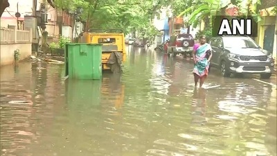 A woman walks on a waterlogged street in Chennai on Wednesday, November 10, 2021. (ANI Photo)