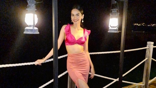 Manushi Chhillar poses in a pink crop top and skirt.