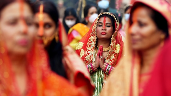Devotees offer prayer to the setting Sun in the artificial pond as they observe Chhath Puja in New Delhi on November 10(Rahul Singh)