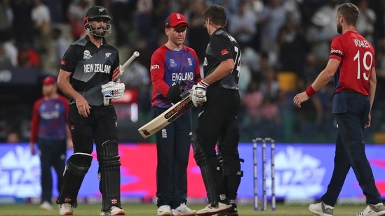 Abu Dhabi : England's captain Eoin Morgan centre, greets New Zealand's Mitchell Santner at the end of the Cricket Twenty20 World Cup semi-final match between England and New Zealand in Abu Dhabi, UAE, Wednesday, Nov. 10, 2021. AP/PTI(AP11_10_2021_000320A)(AP)