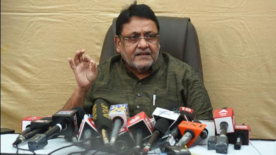 Maharashtra minister Nawab Malik addresses the media during a press conference in Mumbai on Tuesday. (HT photo)