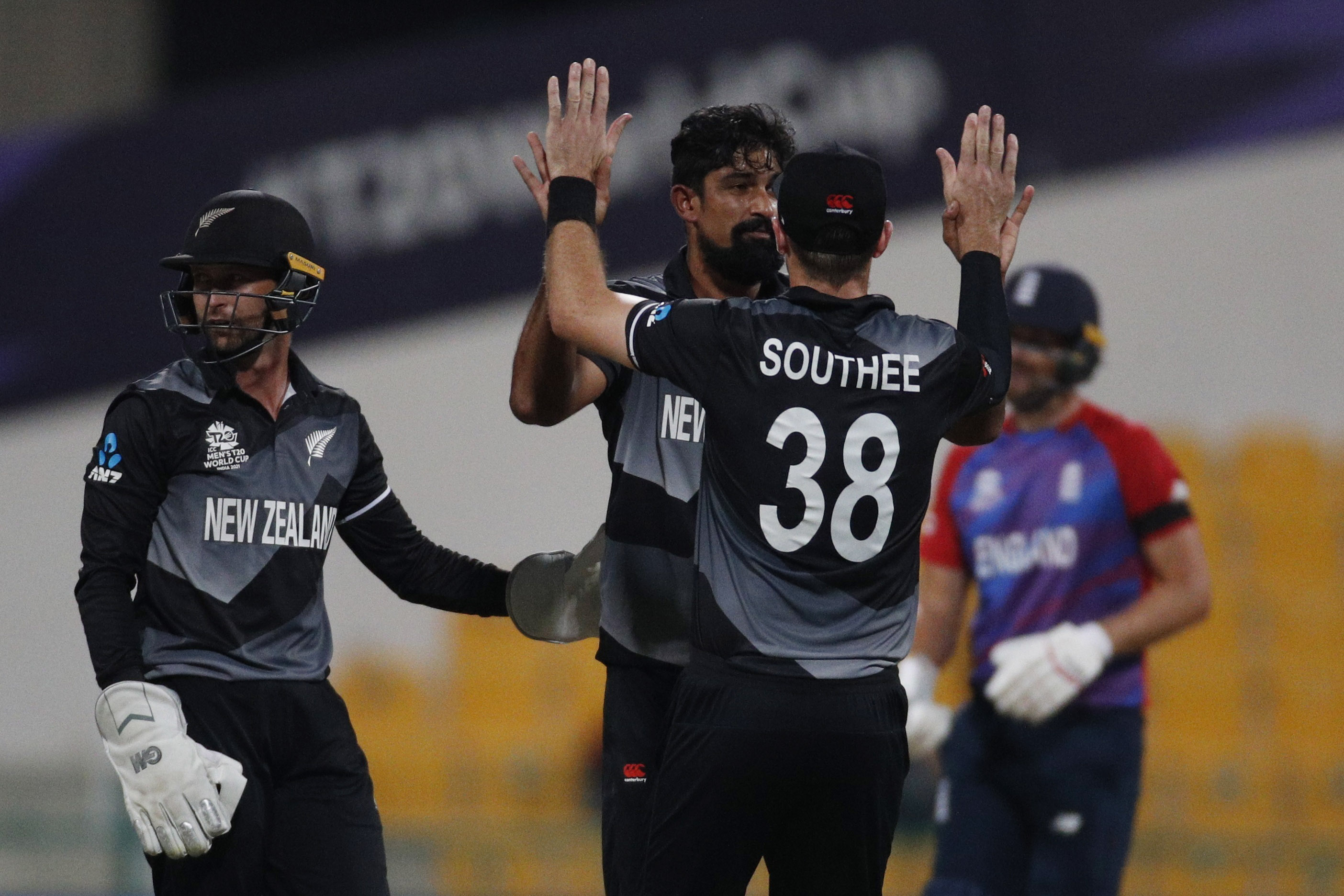 New Zealand's Ish Sodhi celebrates with Tim Southee after taking the wicket of England's Jos Buttler&nbsp; (REUTERS)