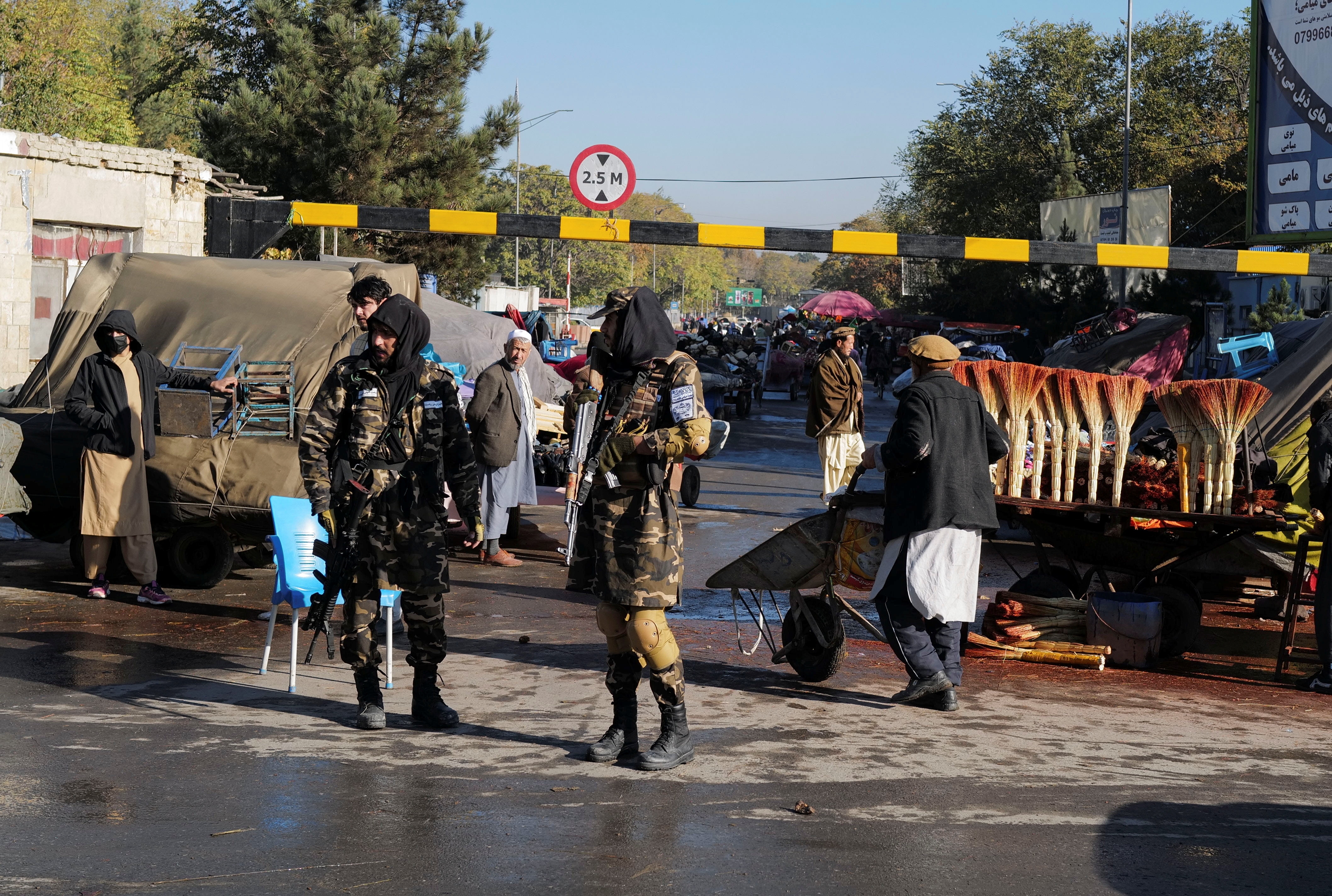 Taliban fighters stand as they hold a checkpoint in Kabul, Afghanistan. (Reuters )