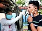 A healthcare worker collects a swab sample of a man for Covid-19 testing at a mobile testing van, in Madhya Pradesh. A healthcare worker collects a swab sample of a man for Covid-19 testing at a mobile testing van, in Madhya Pradesh.