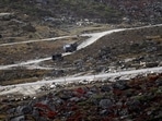 An Indian Army truck drives along a road to Tawang, near the Line of Actual Control (LAC), neighbouring China, near Sela Pass in Arunachal Pradesh (AFP)