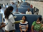 A healthcare worker collects a swab sample of a girl for the Covid-19 test inside a train compartment, in Bengaluru. (ANI) A healthcare worker collects a swab sample of a girl for the Covid-19 test inside a train compartment, in Bengaluru. (ANI)
