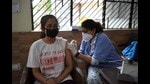 A health worker administers a dose of Covid-19 vaccine to a beneficiary at a community centre, Gurugram, October 2021 (Parveen Kumar/Hindustan Times)