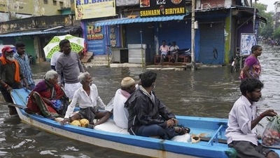 People travel on a boat in floodwaters on the outskirts of Chennai on November 10, 2021. (AP photo) People travel on a boat in floodwaters on the outskirts of Chennai on November 10, 2021. (AP photo)