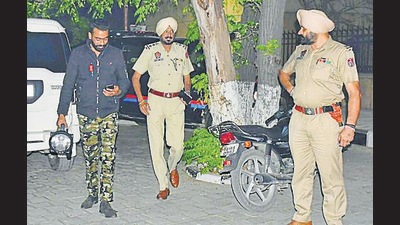 A member of the bomb disposal team and cops at Sarabha Nagar in Ludhiana on Thursday. (Harsimar Pal Singh/HT)