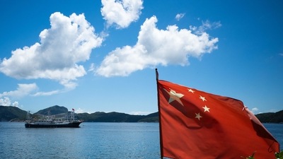 The flag of China flutters as a boat is hankered in Hong Kong on September 4, 2021 (AFP)