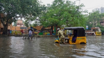 A man pushes his autorickshaw past floodwaters on the outskirts of Chennai. (AP) A man pushes his autorickshaw past floodwaters on the outskirts of Chennai. (AP)