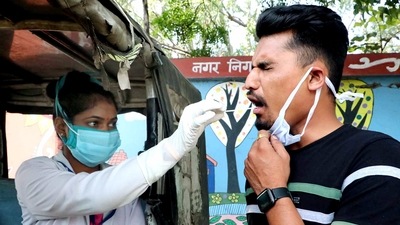 A healthcare worker collects a swab sample of a man for Covid-19 testing at a mobile testing van, in Madhya Pradesh. (ANI File Photo) A healthcare worker collects a swab sample of a man for Covid-19 testing at a mobile testing van, in Madhya Pradesh. (ANI File Photo)