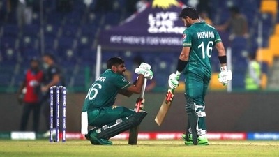 Pakistan's captain Babar Azam, left, talks with Mohammad Rizwan (AP)