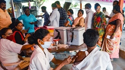 A health worker administers a dose of Covid-19 vaccine to a beneficiary during a vaccination camp in Karad on Wednesday. (PTI) A health worker administers a dose of Covid-19 vaccine to a beneficiary during a vaccination camp in Karad on Wednesday. (PTI)