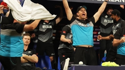 Jimmy Neesham (on left) sits quietly on his chair while New Zealand players, support staff celebrate win against England wildly Jimmy Neesham (on left) sits quietly on his chair while New Zealand players, support staff celebrate win against England wildly