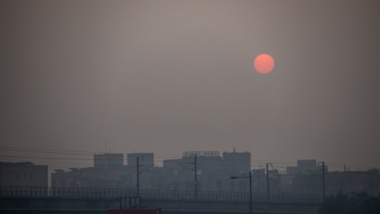 The sun rises over buildings shrouded in smog in New Delhi. (Bloomberg)