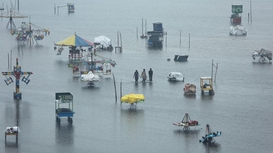 People wade through a flooded beach after heavy rainfall in Chennai. (File Photo / REUTERS) People wade through a flooded beach after heavy rainfall in Chennai. (File Photo / REUTERS)