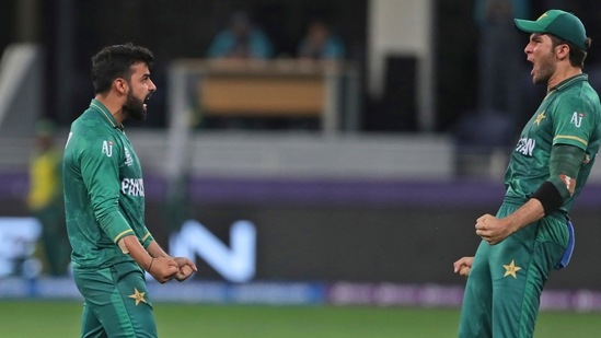 Dubai : Pakistan's Shadab Khan, left, celebrates the dismissal of Australia's David Warner with Shaheen Afridi during the Cricket Twenty20 World Cup second semi-final match between Australia and Pakistan in Dubai, UAE, Thursday, Nov. 11, 2021. AP/PTI(AP11_11_2021_000263B)(AP)