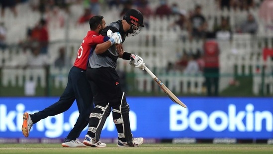 England's bowler Adil Rashid, left, collides with New Zealand's batsman Daryl Mitchell during the Cricket Twenty20 World Cup semi-final match between England and New Zealand in Abu Dhabi, UAE, Wednesday, Nov. 10, 2021. &nbsp;(AP)