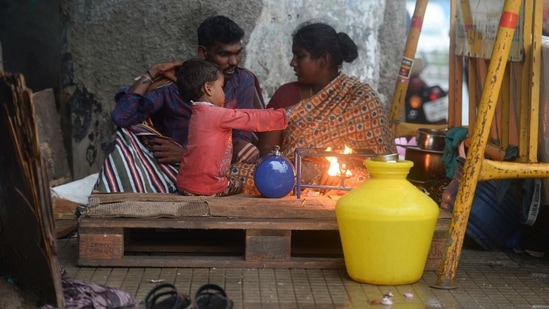 A homeless family shelters under a bridge during a heavy monsoon rainfall in Chennai on November 10. 11 National Disaster Response Force (NDRF) and 7 State Disaster Response Force (SDRF) teams have been deployed in Tamil Nadu as of now, informed Tamil Nadu Revenue and Disaster Management Minister KKSSR Ramachandran(AFP)