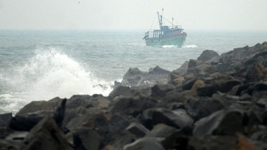 A fishing boat approaches Kasimedu fishing harbour during a heavy monsoon rainfall in Chennai on November 10.(AFP)