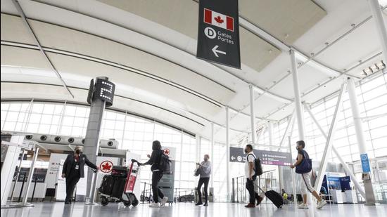 Travellers arrive at a check-in area at Toronto Pearson International Airport in Ontario. Canada is registering a record intake of students from India this year, but a leading immigration lawyer and charity groups are warning of the challenges these newcomers face on arrival. (Bloomberg) Travellers arrive at a check-in area at Toronto Pearson International Airport in Ontario. Canada is registering a record intake of students from India this year, but a leading immigration lawyer and charity groups are warning of the challenges these newcomers face on arrival. (Bloomberg)