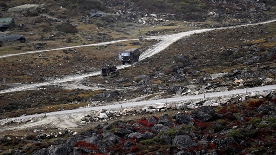 An Indian Army truck drives along a road to Tawang, near the Line of Actual Control (LAC), neighbouring China, near Sela Pass in Arunachal Pradesh (AFP)