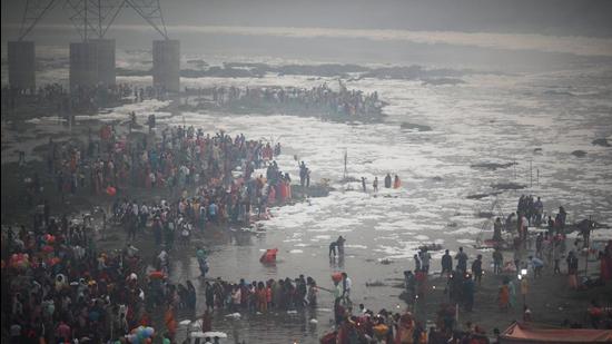 Devotees are seen on the banks of the Yamuna river in New Delhi on Wednesday. On Thursday, the Capital’s air quality slipped back to the ‘severe’ category. (REUTERS)