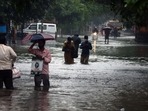 People wade through a waterlogged road following heavy rainfall, in Chennai.(L. Anantha Krishnan) People wade through a waterlogged road following heavy rainfall, in Chennai.(L. Anantha Krishnan)