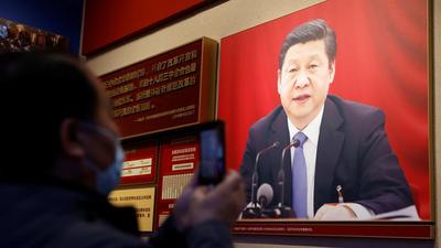 A man holds a mobile phone in front of an image of Chinese President Xi Jinping displayed at the Museum of the Communist Party of China in Beijing. (REUTERS) A man holds a mobile phone in front of an image of Chinese President Xi Jinping displayed at the Museum of the Communist Party of China in Beijing. (REUTERS)