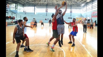 Players in action during the Punjab basketball championship at the Guru Nanak Stadium in Ludhiana on Friday. (HT Photo)