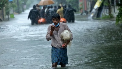 File photo: A man walks through a water-logged road during heavy rains in Chennai. (REUTERS)