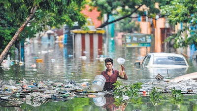 A man wades through a waterlogged street at a residential area after a heavy monsoon rainfall in Chennai on Friday. (AFP) A man wades through a waterlogged street at a residential area after a heavy monsoon rainfall in Chennai on Friday. (AFP)