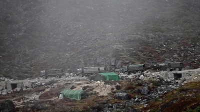 A convoy of Indian Army trucks drives along a road to Tawang, near the Line of Actual Control neighbouring China A convoy of Indian Army trucks drives along a road to Tawang, near the Line of Actual Control neighbouring China