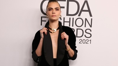 Cara Delevingne gives off Boss Lady vibes in black blazer, skirt and boots at the 2021 CFDA Awards. (REUTERS)