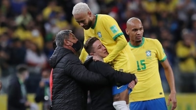 Pitch invader is seen holding Brazil's Neymar after the match&nbsp; (REUTERS)