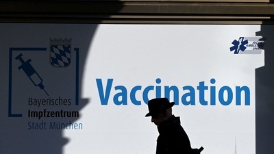 A man walks in front of a vaccination center in the city of Munich, southern Germany. (AFP) A man walks in front of a vaccination center in the city of Munich, southern Germany. (AFP)