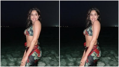 Janhvi posed in a black bikini with red floral motifs. (Instagram/@janhvikapoor) Janhvi posed in a black bikini with red floral motifs. (Instagram/@janhvikapoor)
