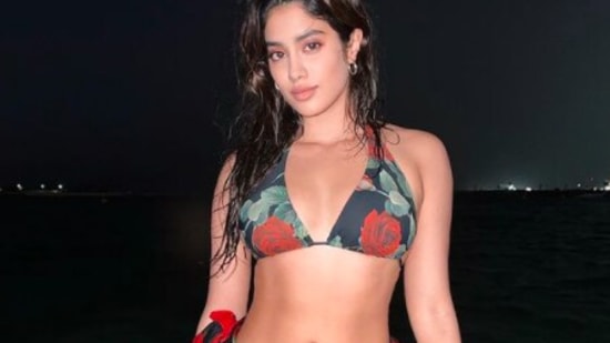 Fitness enthusiast Janhvi Kapoor flaunted her abs as she posed in the floral swimwear at a beach in Dubai.(Instagram/@janhvikapoor)