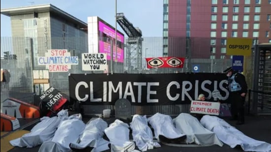 People protest outside the UN Climate Change Conference (COP26) venue in Glasgow, Scotland, on Thursday. (REUTERS)