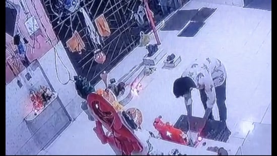 CCTV footage of the burglar touching the feet of Lord Hanuman at a temple in Thane before stealing the donation box. (HT PHOTO)