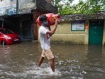 A man carries a cooking gas cylinder and wades past a flooded street in Chennai, in the southern Indian state of Tamil Nadu, (File Photo / AP) A man carries a cooking gas cylinder and wades past a flooded street in Chennai, in the southern Indian state of Tamil Nadu, (File Photo / AP)