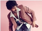 Kartik Aaryan, who is awaiting the release of his upcoming film Dhamaka, is treating his Instagram family regularly with sets of pictures of himself from his promotion diaries. The actor, for Saturday, slayed fusion fashion in a quirky printed white shirt and a coral blazer. (Instagram/@kartikaaryan)